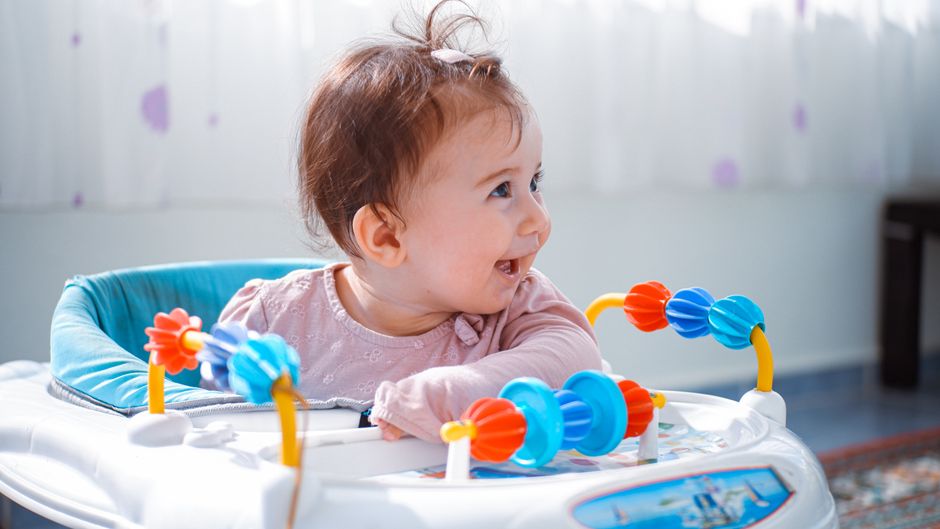 A happy baby exploring developmental play safely