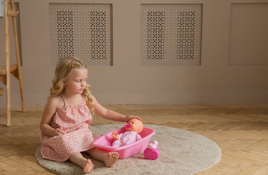 Young girl playing with toys indoors in cozy setting