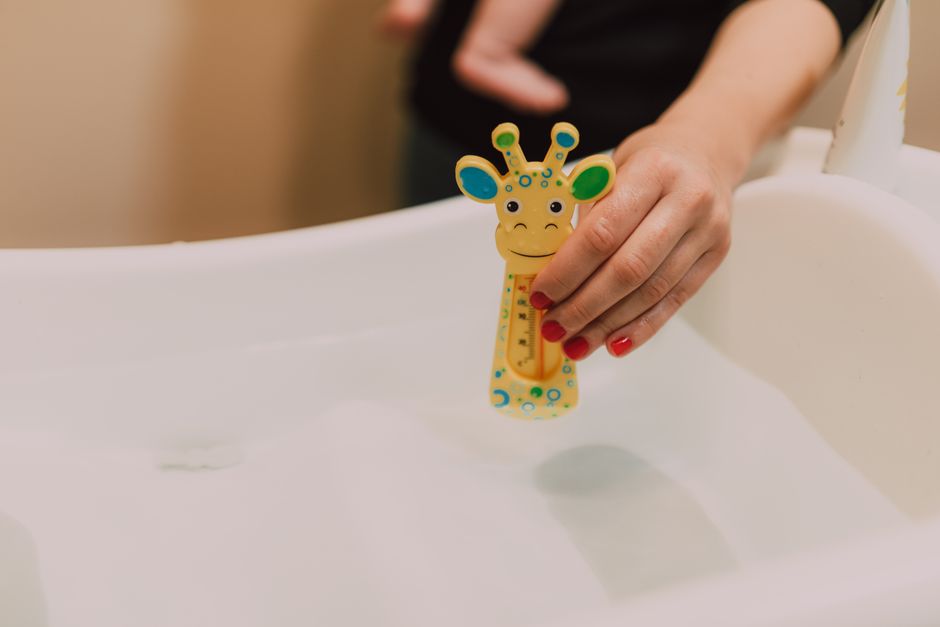 A joyful young child playing with bubbles safely in a bathtub