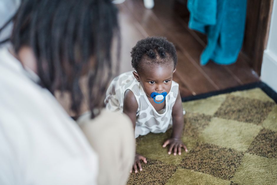 A crawling infant exploring comfortably indoors