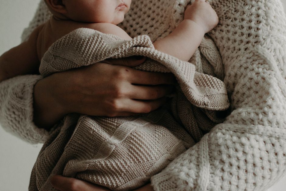 Mother holding and comforting her baby tenderly