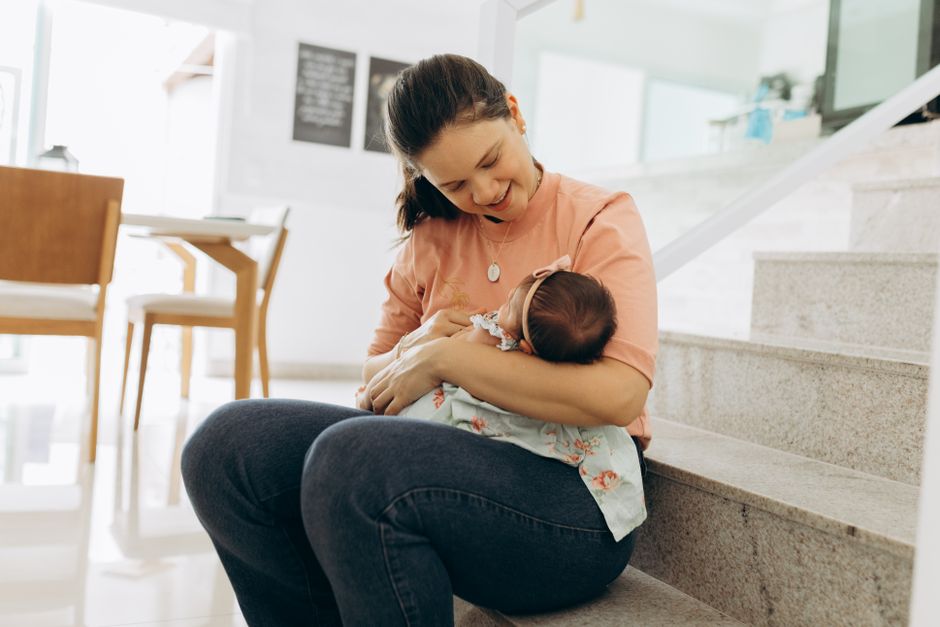 Mother holding infant baby comfortably
