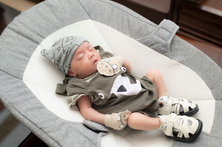 A serene baby resting safely in a comfortable bassinet