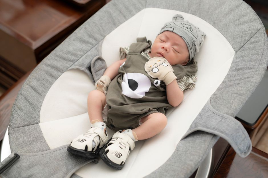 A relaxed infant sleeping peacefully in comfortable clothing