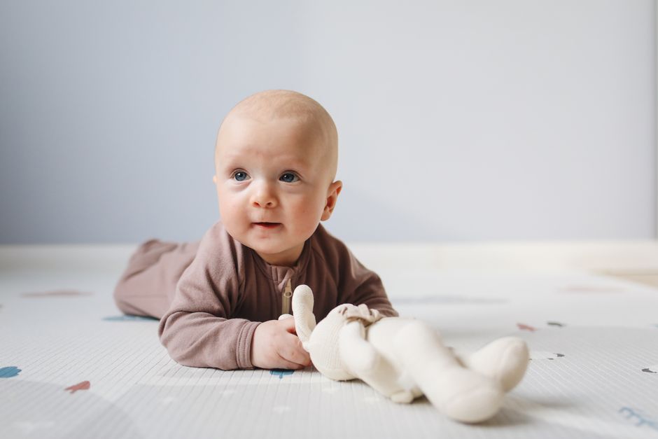 Cute baby on floor with soft toy
