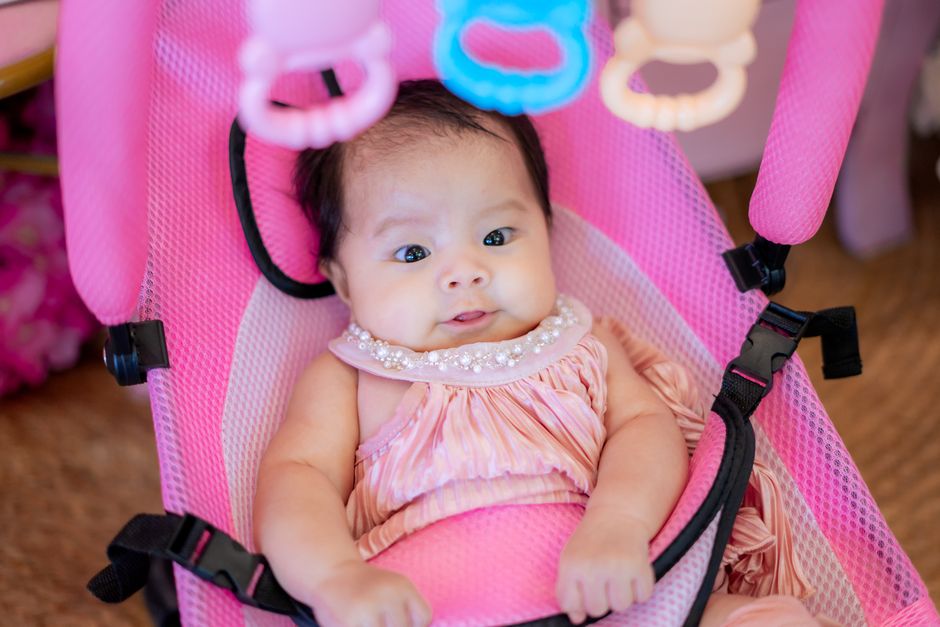 A baby sitting in a safe, ergonomic developmental environment