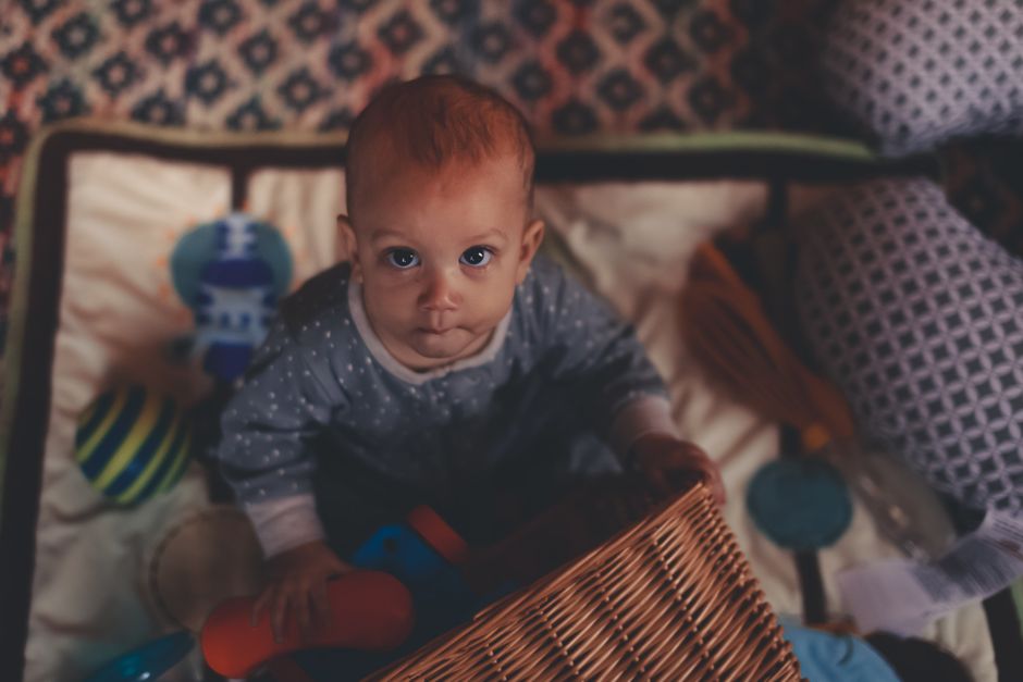 A baby exploring toys freely on the floor in a relaxed natural posture