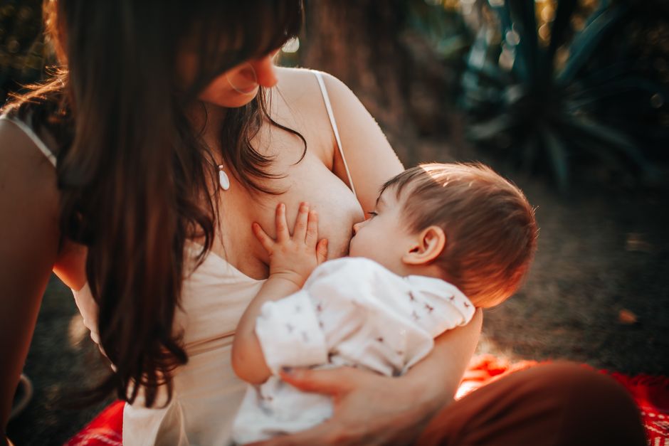 Mother nursing her baby in natural soothing light