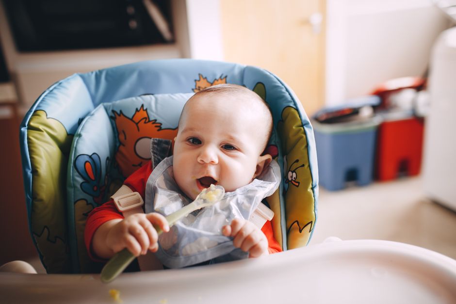 An adorable baby seated in an ergonomic high chair with proper posture