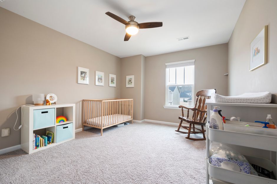 Bright minimalist children's room with clean crib and storage