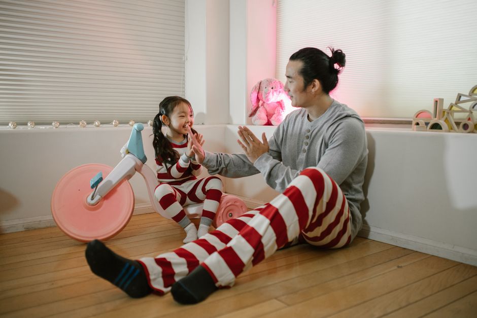 Father and child sharing a joyful play moment at home