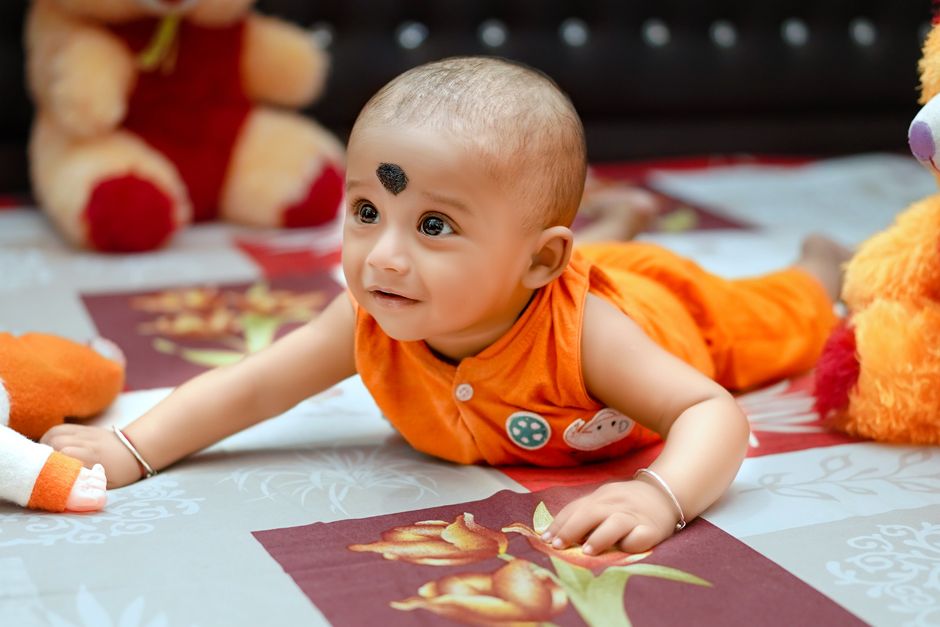 Baby playing on the floor with colorful toys