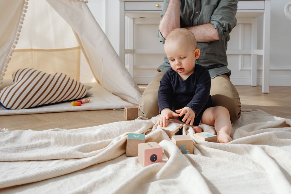 A curious baby playing with educational toys in a safe room