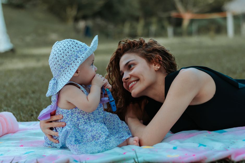 Mother and baby smiling outdoors in natural light