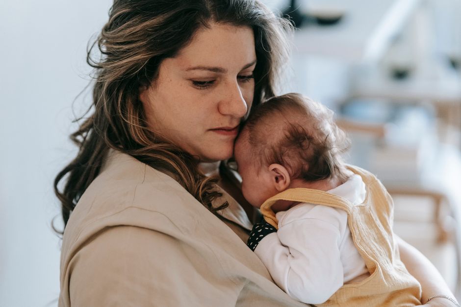 Mother gently holding baby in comforting embrace