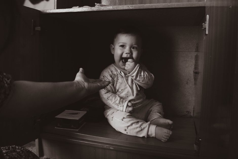 A curious toddler exploring furniture safely