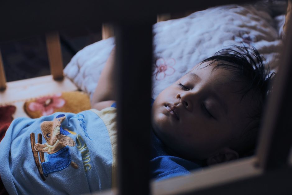 Baby resting calmly in crib during daytime sleep routine