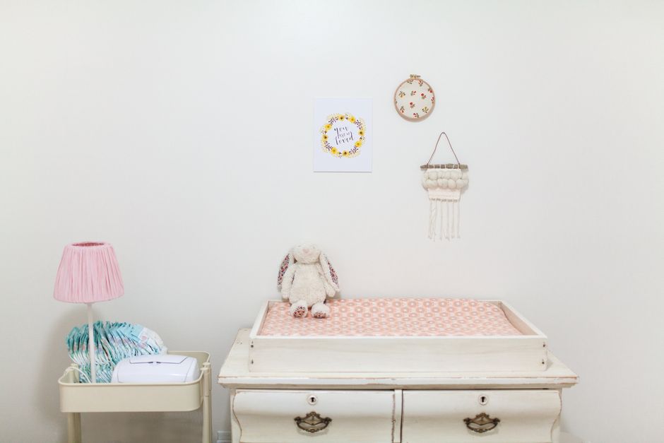 A clean and organized baby diaper changing table in a nursery
