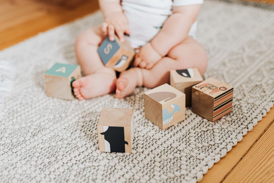 Child playing safely on a clean, baby-proofed living room floor