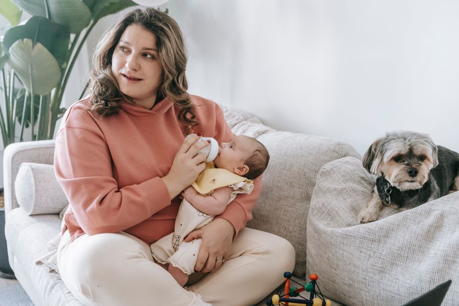Caring mother holding her baby in an upright burping position