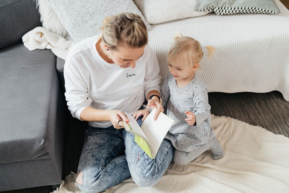 A mother and child share a cozy moment reading a book together