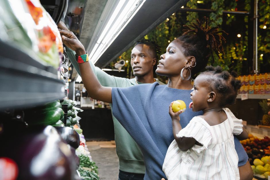 A mother remaining calm and grounded while co-regulating with her emotional toddler in public