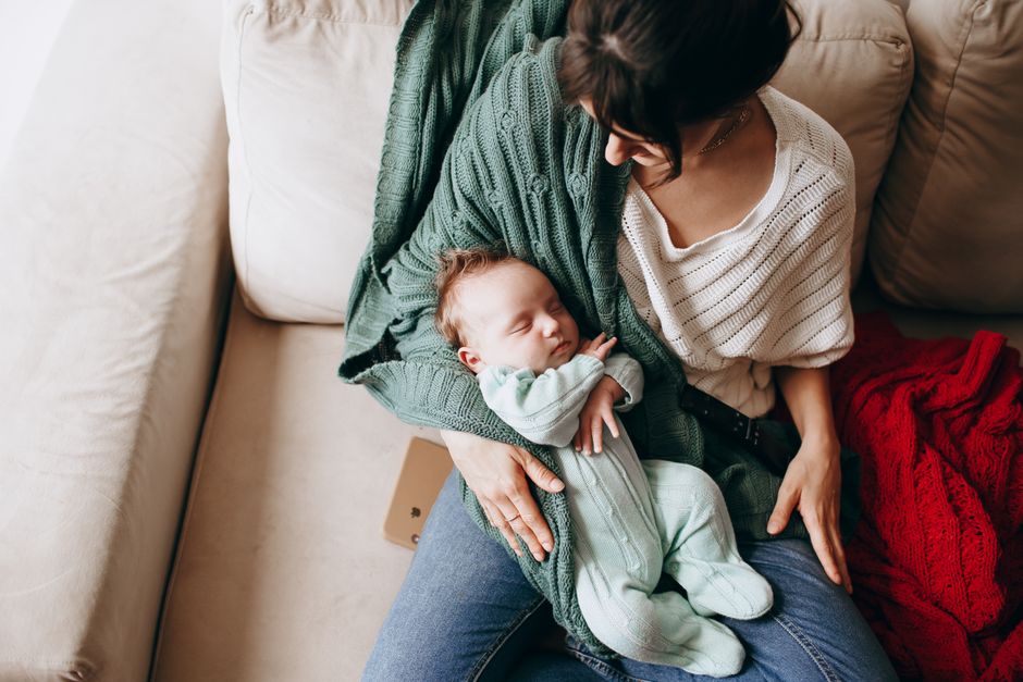 Mother gently holding her baby with warmth and comfort indoors