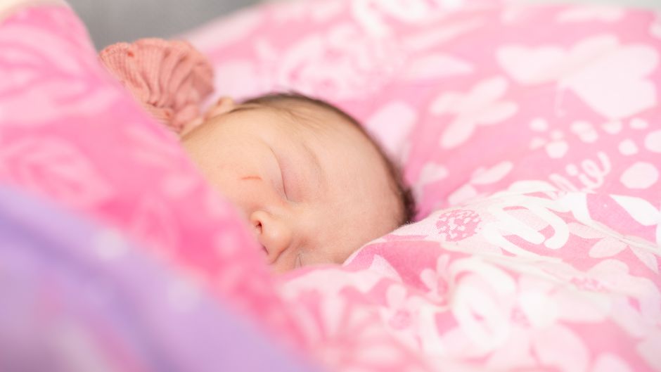 Peaceful sleeping baby resting comfortably in a soft crib