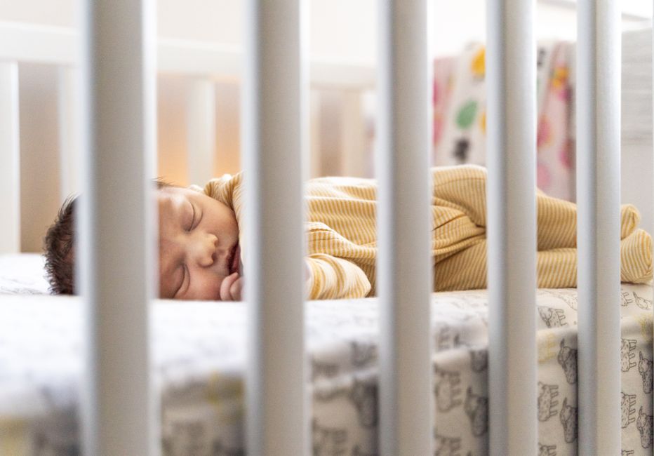 Serene baby resting peacefully in a safe nursery crib