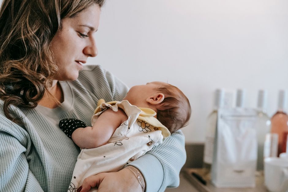 Mother lovingly holding her baby in soft living room