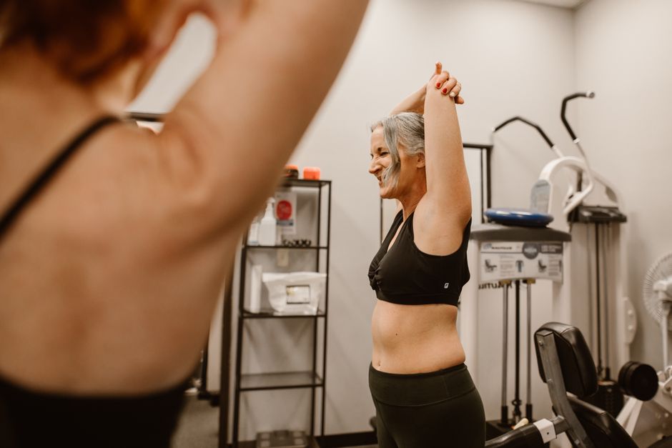 Postpartum mother gently stretching and restoring mobility during a wellness routine