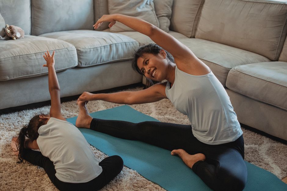 Mother stretching comfortably with daughter
