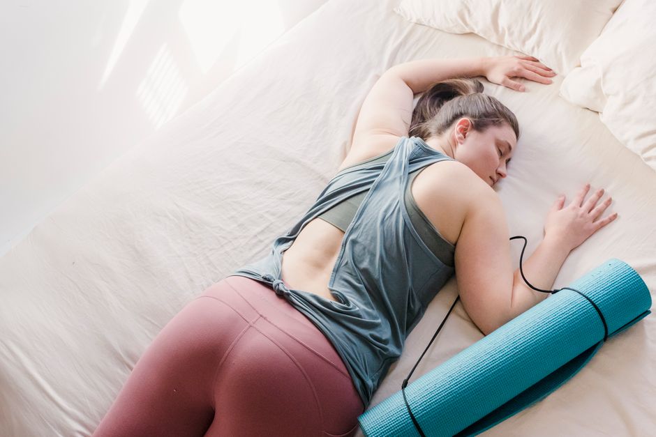 A woman resting comfortably after establishing an intentional recovery routine