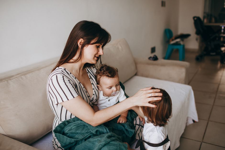 A caring mother supporting her young child with gentle connection and emotional co-regulation