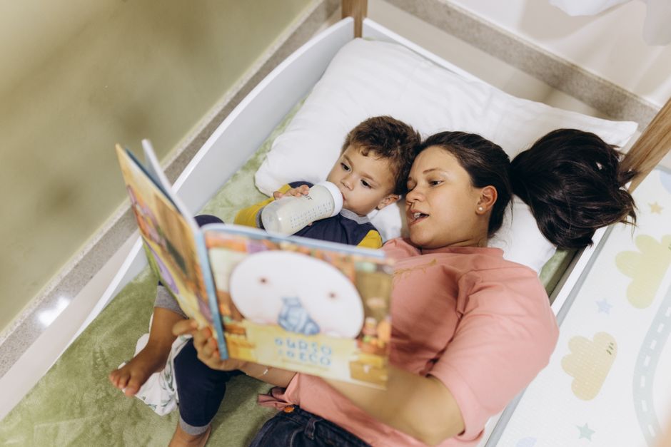 A mother reading a bedtime book to her young son