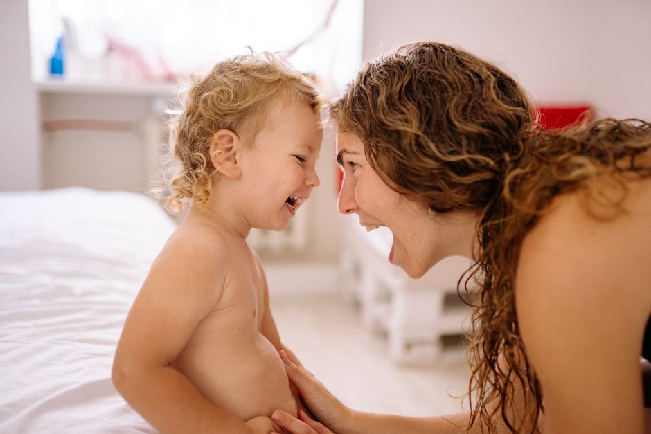 Mother and child in a living room discussing boundaries with calm connection