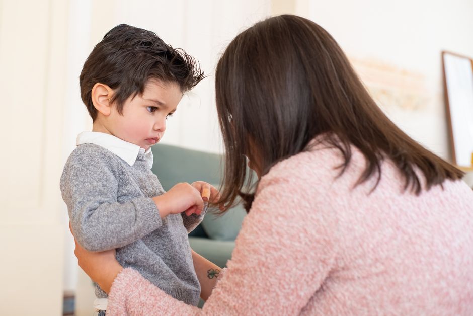 Patient mother calmly connecting and consoling her young toddler in a serene living room