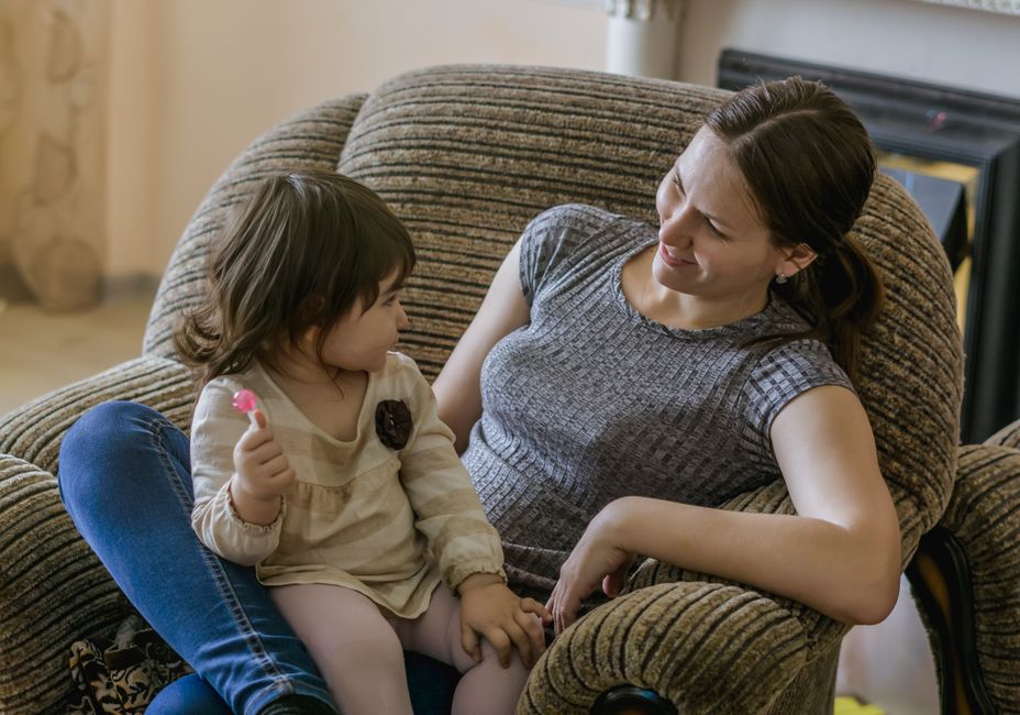 Mother and daughter sharing a warm, peaceful moment on a comfortable sofa
