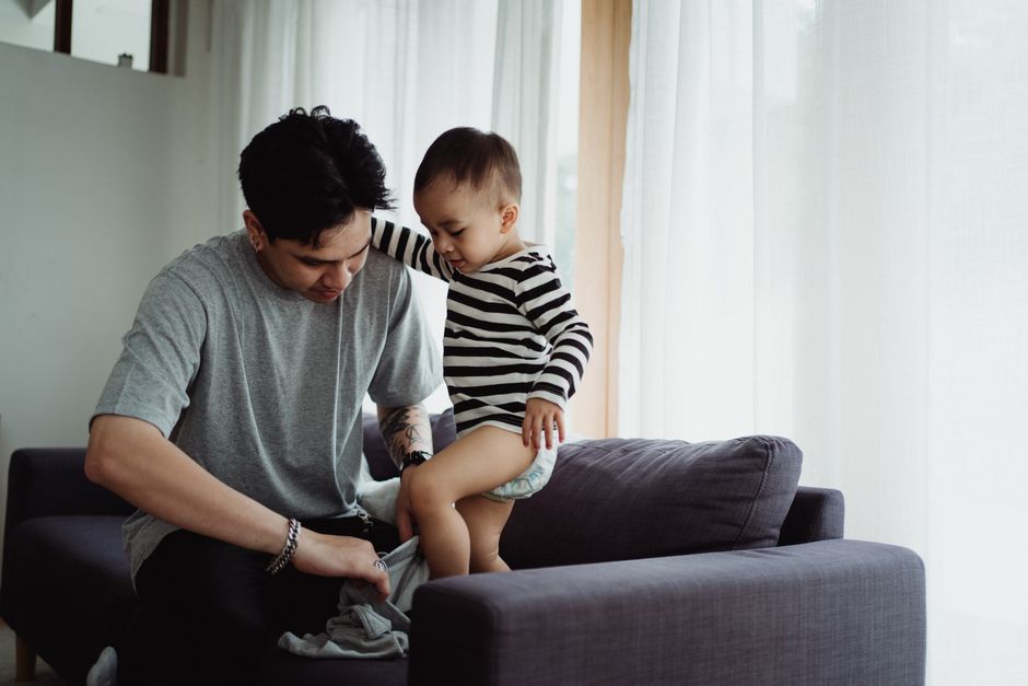 Parent connecting gently with young child on sofa