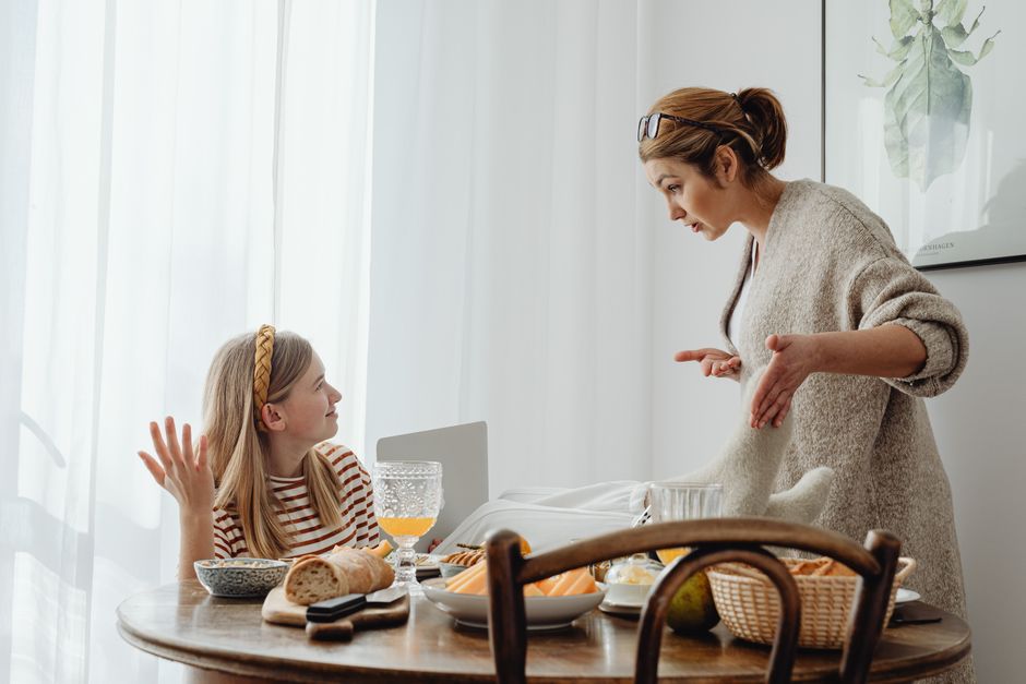 A mother calmly connecting and communicating with her toddler at home