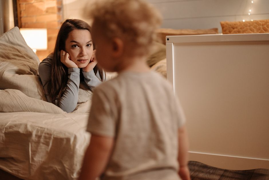 A tender moment between mother and toddler in nursery