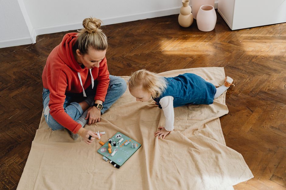 Mother and daughter enjoying interactive playful communication indoors