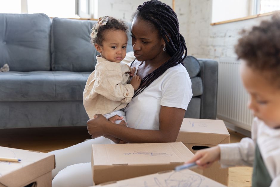 Mother holding overwhelmed toddler with compassionate care