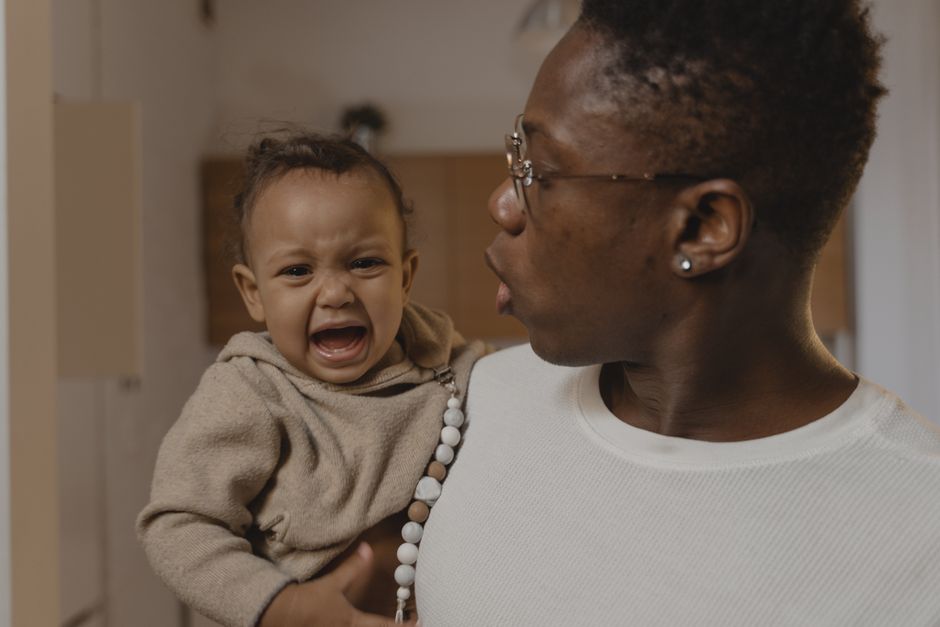 Father holding upset child with gentle empathy