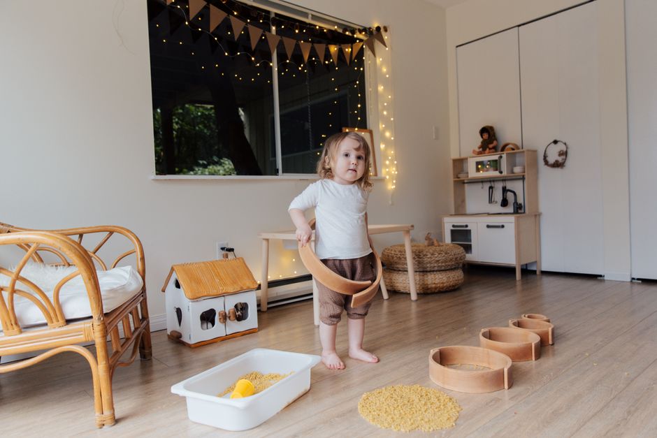 Adorable toddler girl engaging in barefoot floor play developing balance