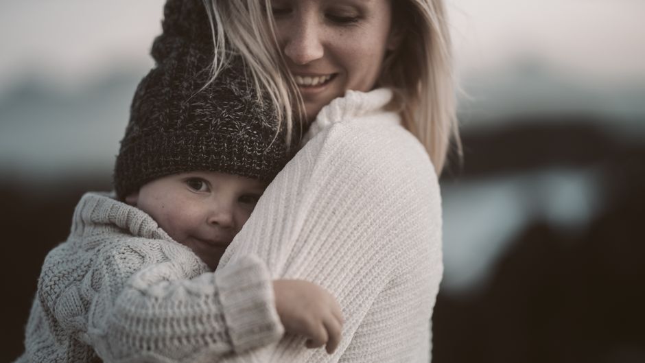 Loving mother comforting her toddler with warmth and empathy outdoors