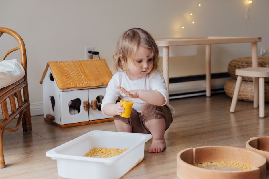 Young toddler engaging in safe and creative sensory floor play at home