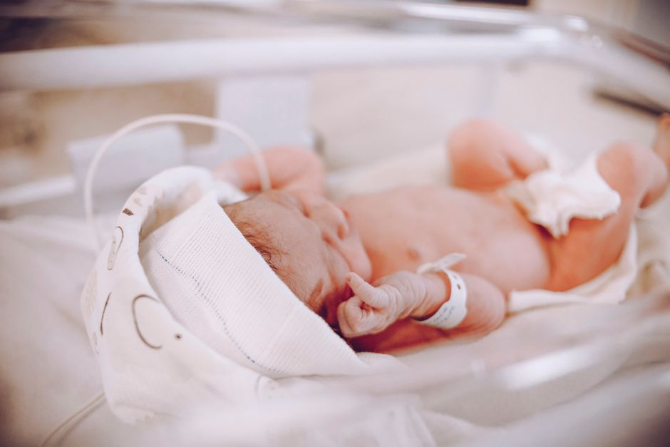Newborn resting safely in a bassinet