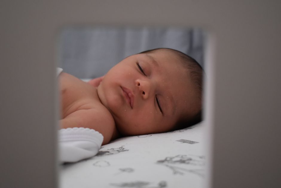 A sleeping infant resting safely indoors